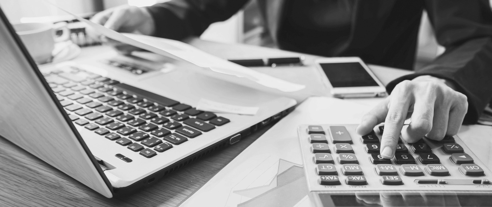 A CPA and business owner reviewing financial statements together in a modern office