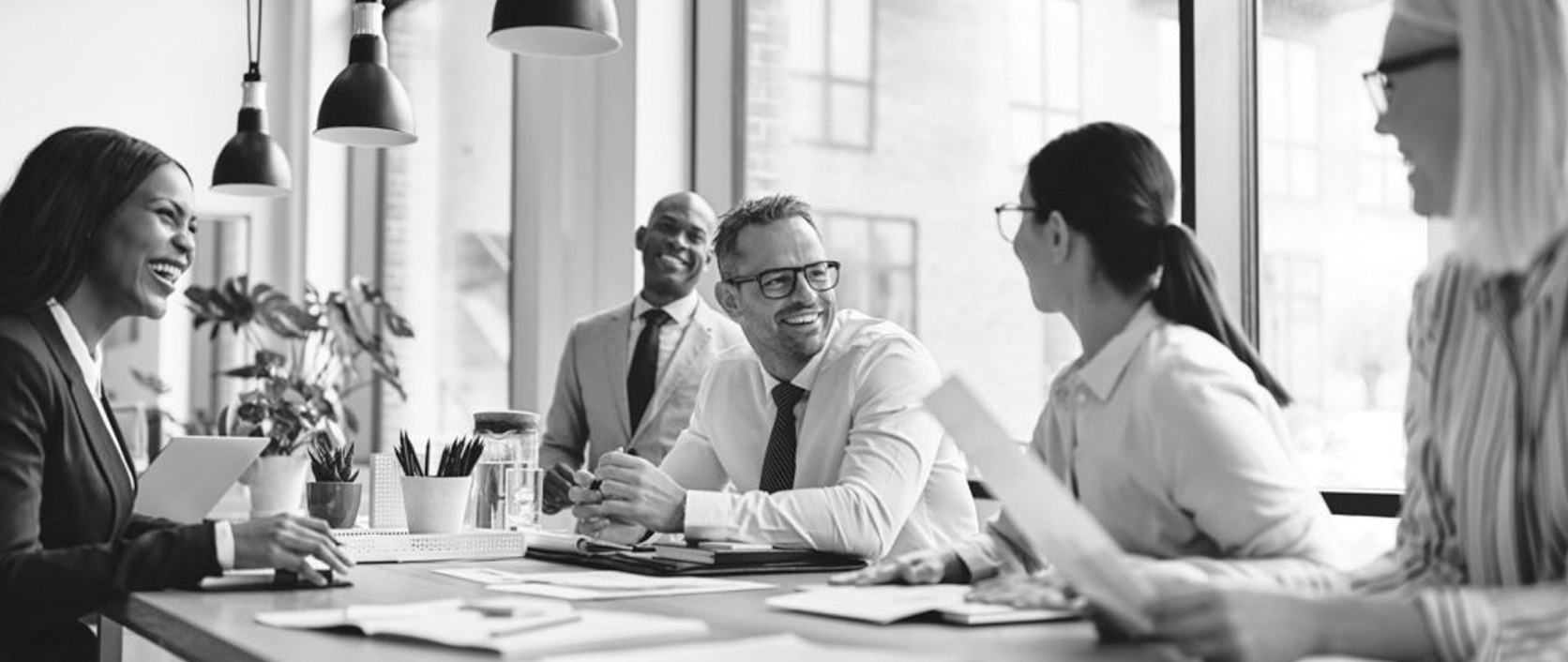 A consultant facilitating a working strategy session with clients around a table