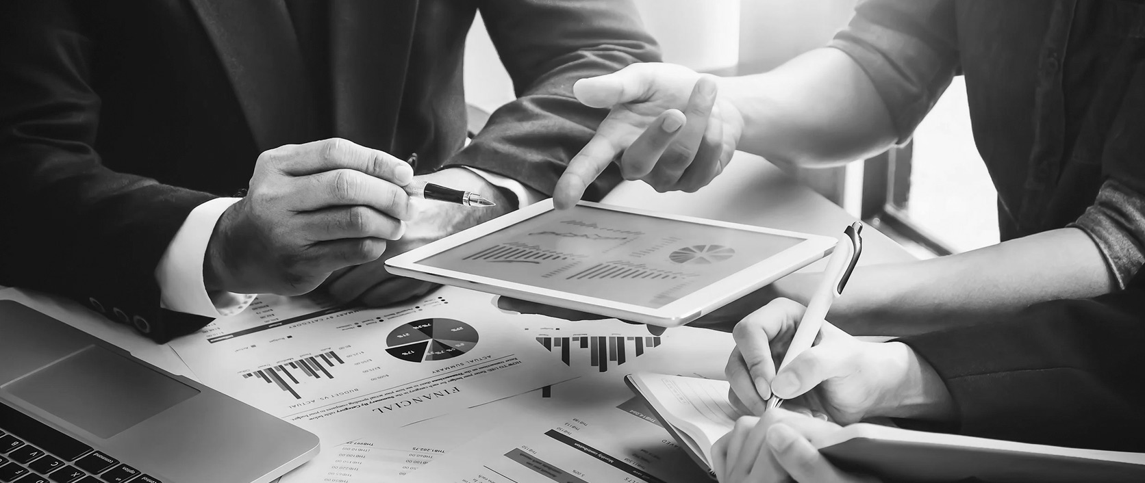 A financial advisor and client reviewing a financial plan together in a modern office