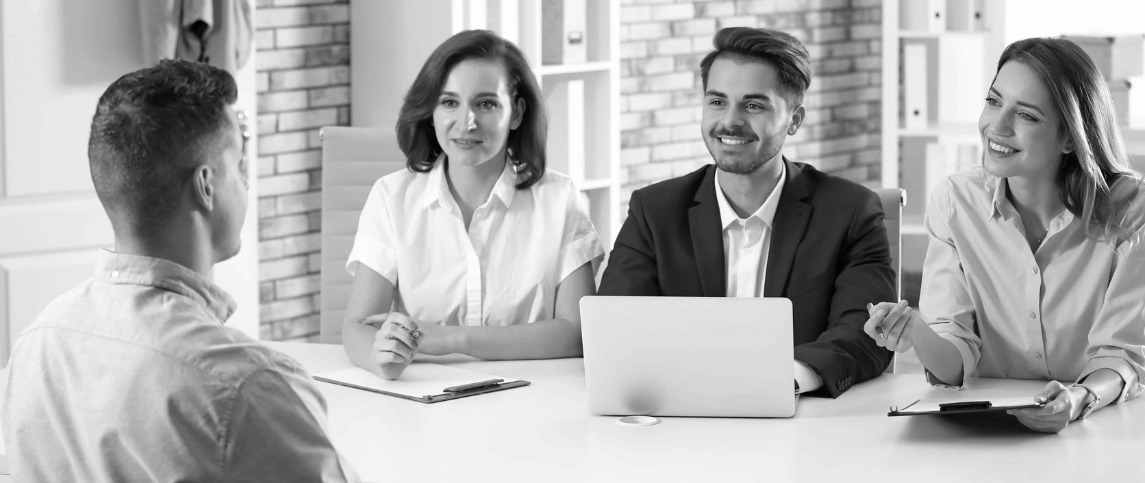 A recruiter meeting with a hiring manager and candidate in conversation