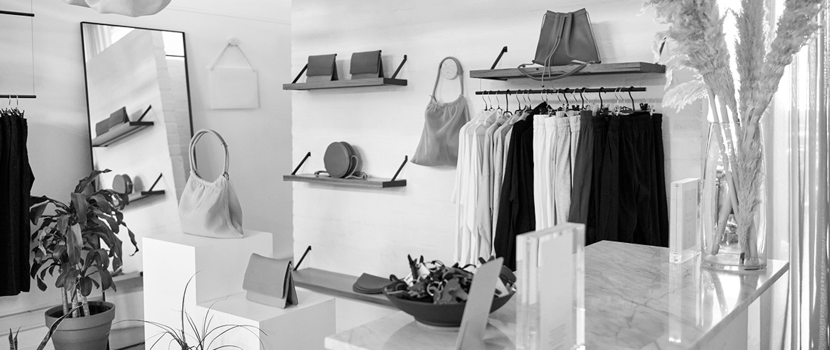 A shop owner helping a customer in a distinctive boutique store surrounded by real products